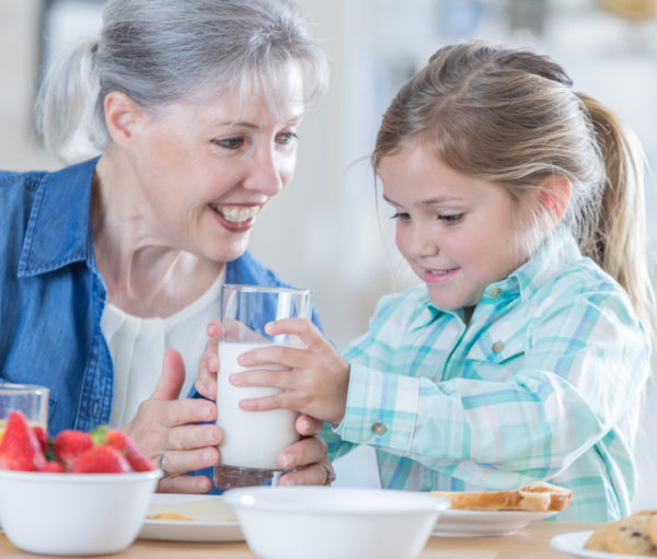 Grandaughter and grandmother having breakfast